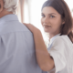 Pflegerin gibt Senior Informationen zur 24-Stunden-Pflege